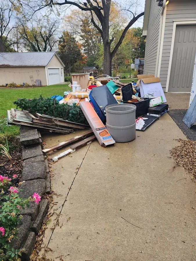 Dumpster being loaded with debris for Estate Cleanout Dumpster Rental in St. Cloud